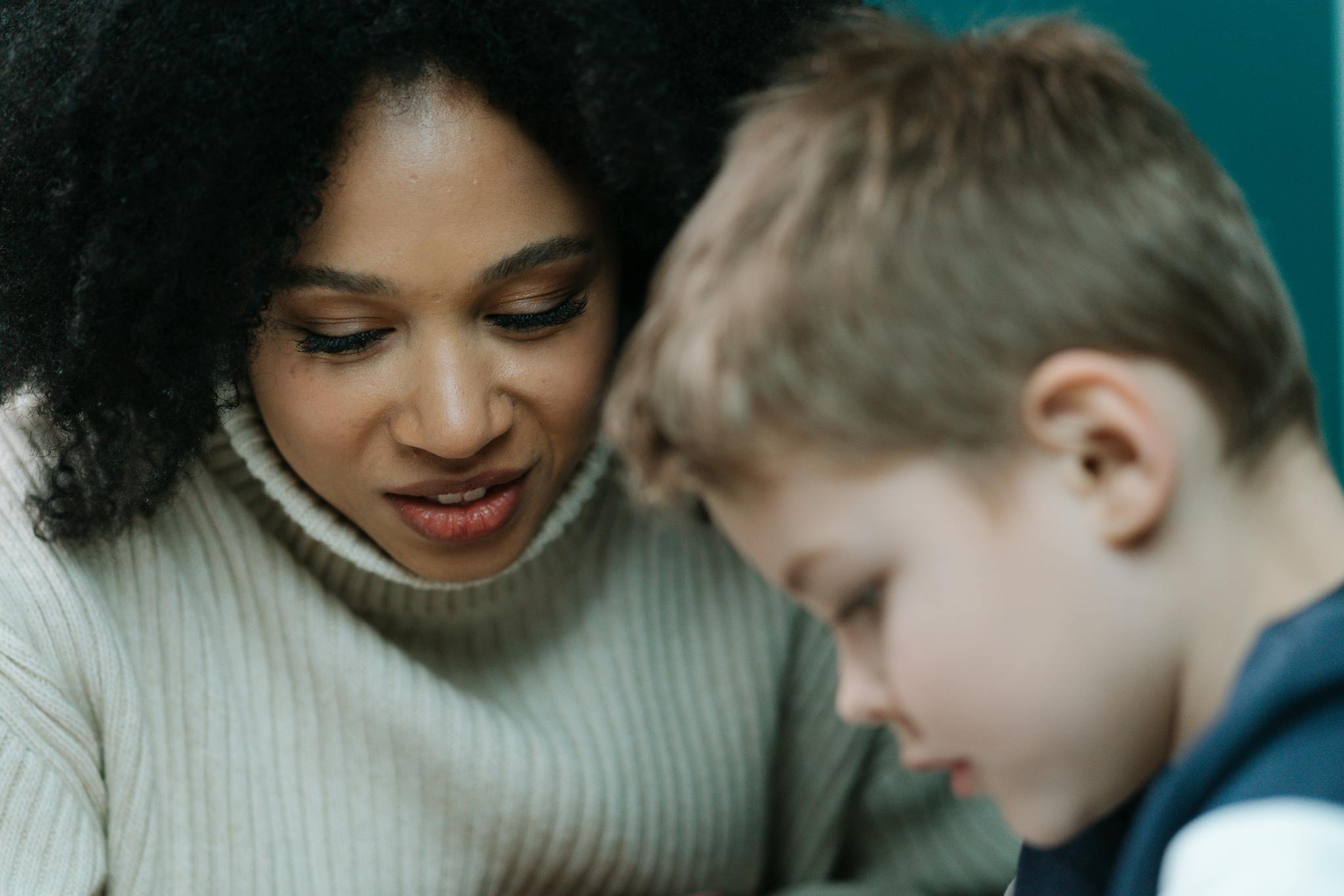 A caregiver attentively interacts with a child, fostering learning and connection.